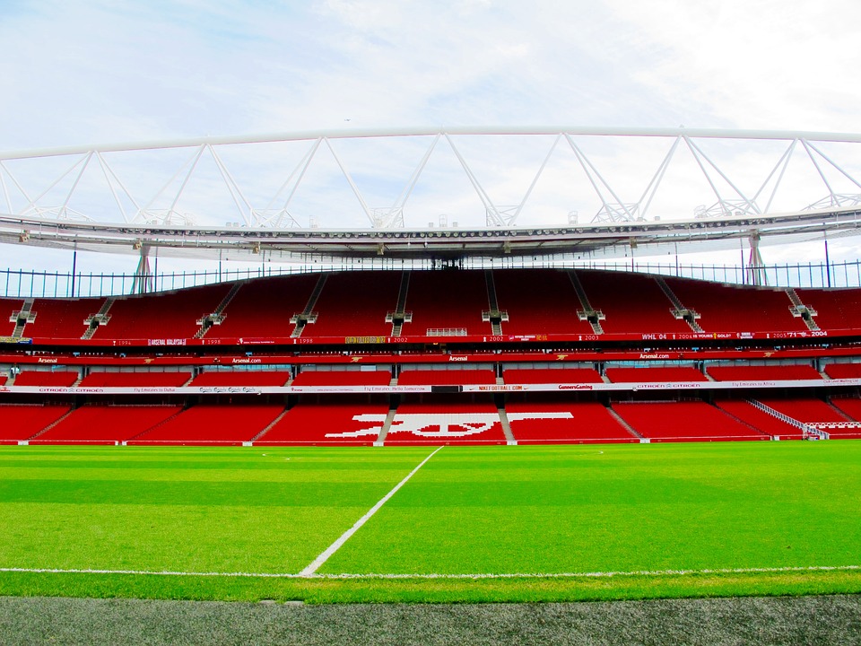 Empty Emirates Stadium view, with gunners symbol on chairs